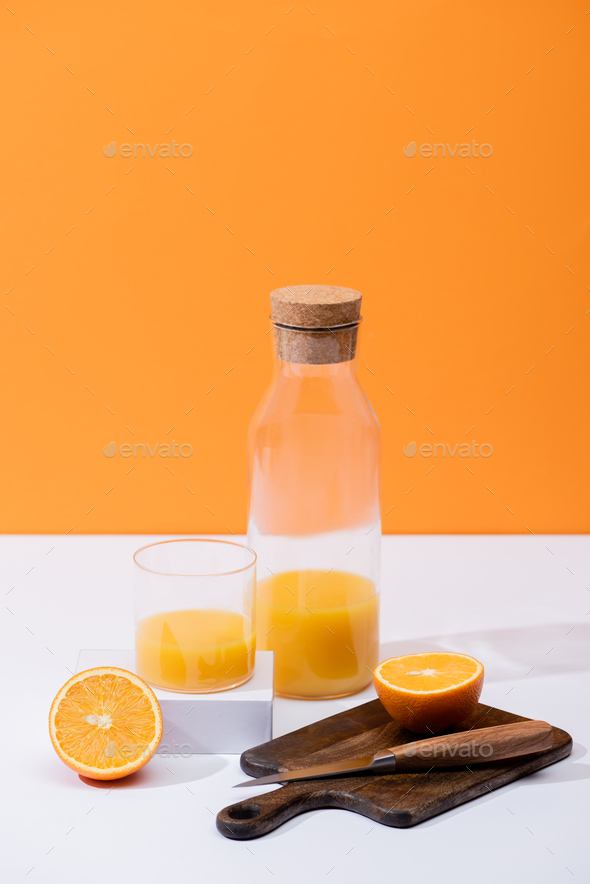 Jug of orange juice and orange fruits isolated on white, Stock image