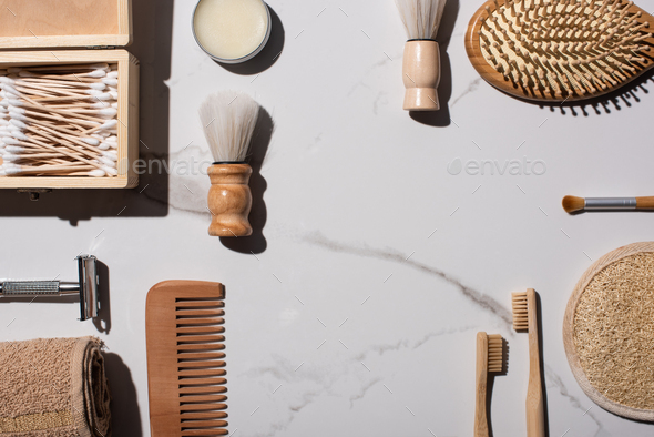 Top view of shaving and cosmetic brushes, comb, towel, toothbrushes