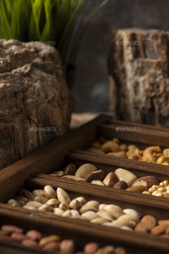 Mix of Nuts in a wooden box with stones for decor