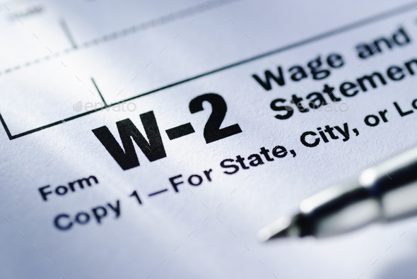 Pen on a Form W-2 Wage and Tax Statement - Stock Photo - Images