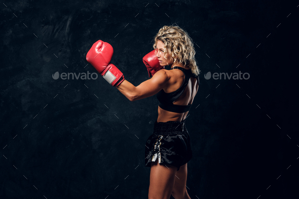 Portrait of professional female boxer in action