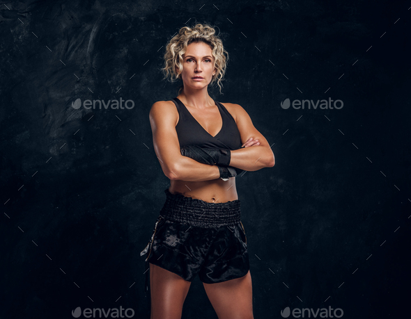 Portrait of expirienced female boxer in photo studio