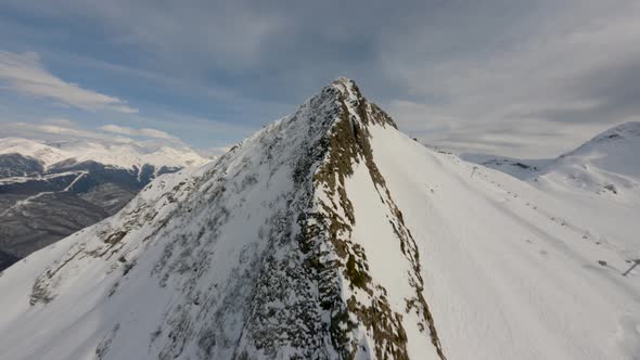 Aerial View Sports FPV Drone Raising Up Top of Mount Black Pyramid Dive Down Cliff at High Speed alt