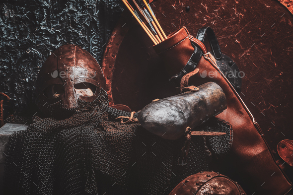 Still life with ancient shield, two rusted helmets, quiver of arrows