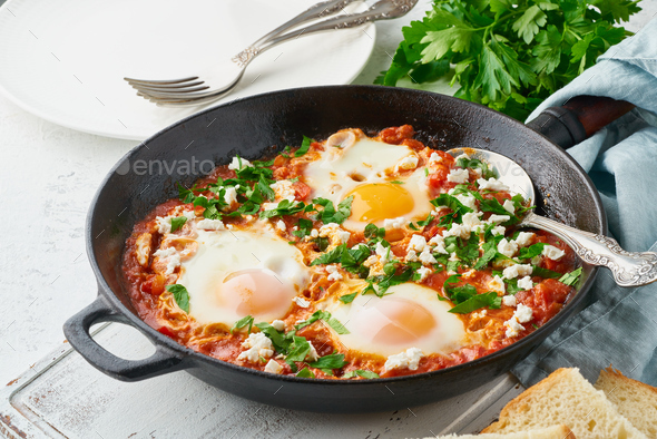 Shakshouka, eggs poached in sauce of tomatoes, olive oil. Mediterranean cuisine. - Stock Photo - Images