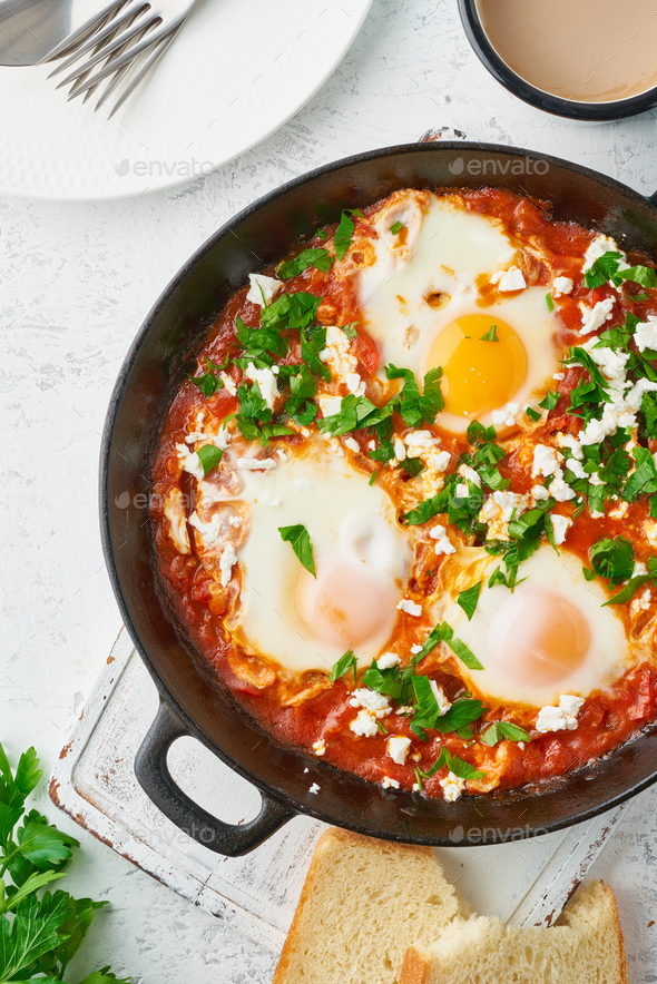 Shakshouka, eggs poached in sauce of tomatoes, olive oil. Mediterranean cousine. - Stock Photo - Images