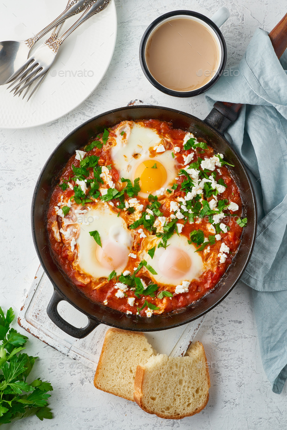 Shakshouka, eggs poached in sauce of tomatoes, olive oil. Mediterranean cuisine. - Stock Photo - Images
