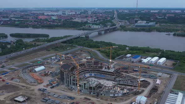 Construction Site of Sports Arena Near Bridge on Riverbank alt