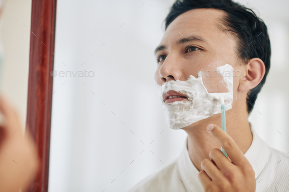 Shaving young man