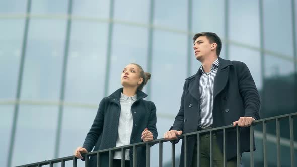 Businesswoman and Businessman Discussing New Project or Working Plan Outdoor alt