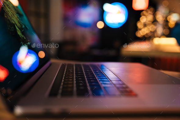 Photo of qualitative modern laptop with neon reflections