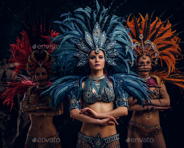 Premium Photo  Three woman in brazilian samba carnival costume with  colorful feathers plumage.