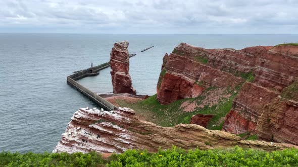 Wide shot showing famous Lange Anna or Tall Anna on Helgoland Island in Germany alt