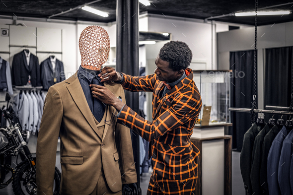 Handsome elegantly dressed African-American man in a classic menswear store