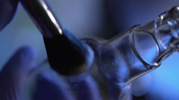 Close Shot of Revealing Latent Fingerprint from Bottle, Using Brush and Powder alt