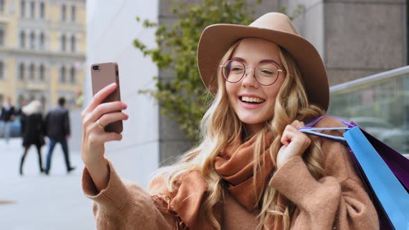 Attractive Girl Blogger Shoots Video for Blog After Shopping Standing on Street in City Caucasian alt