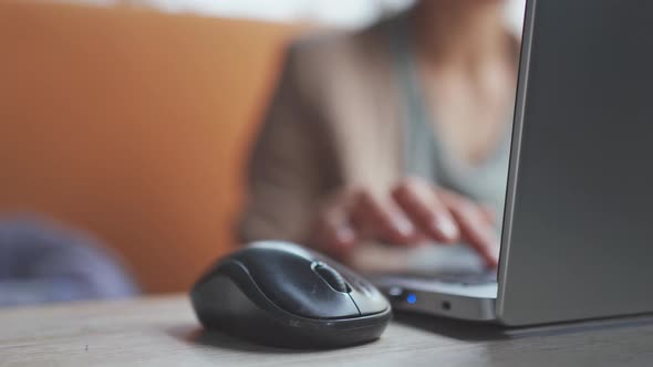 Closeup Selective Focus Female Hand Scrolling Mouse at Laptop Computer alt