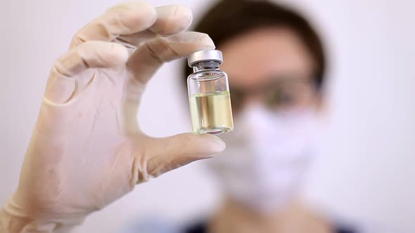 A Doctor or Nurse in Nitrile Gloves Holds in His Hand a Vaccine Vaccinated Against Influenza