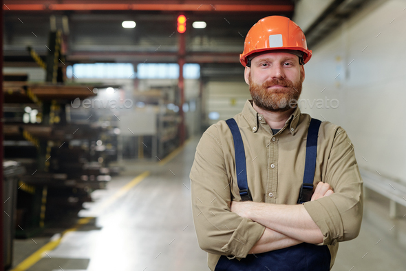 Brutal factory man in hardhat - Stock Photo - Images