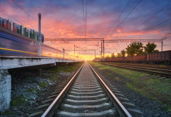 Railway station with freight trains at colorful sunset Stock Photo by  den-belitsky