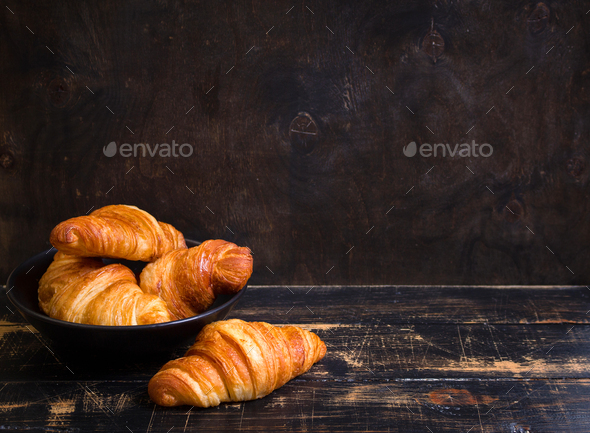 Croissants in a black bowl on the dark background - Stock Photo - Images