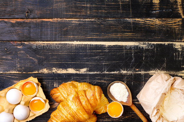 Croissants, flour, eggs, spoon background - Stock Photo - Images