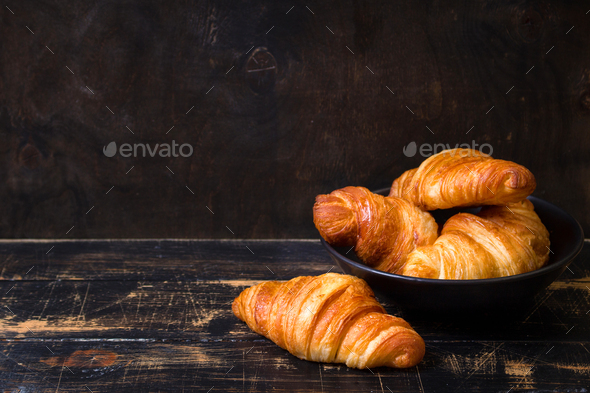 Croissants in a black bowl on the dark background - Stock Photo - Images