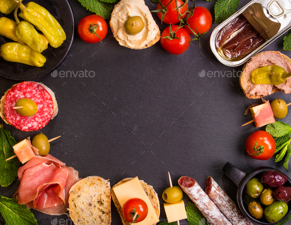 Spanish tapas on a black stone background - Stock Photo - Images
