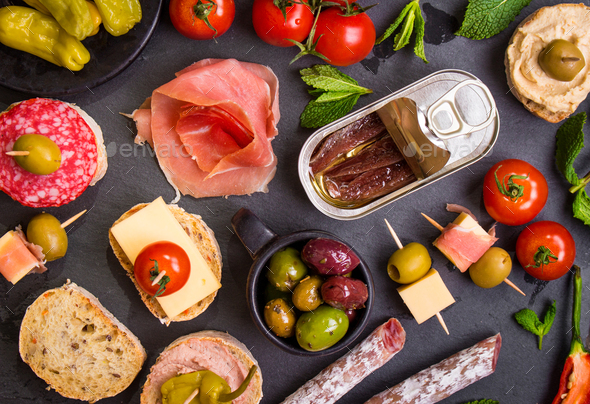 Spanish tapas on a black stone - Stock Photo - Images