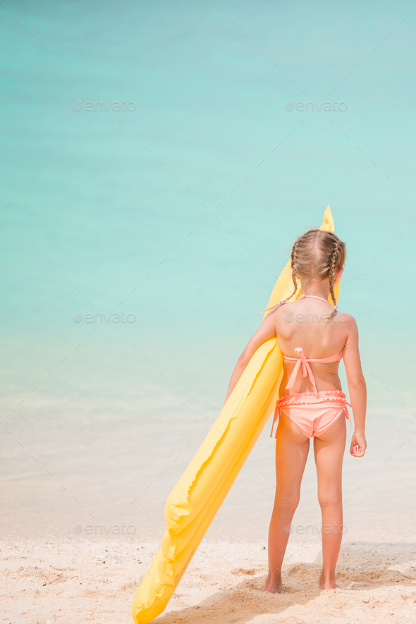 Adorable little girl have fun at tropical beach during vacation Stock Photo  by travnikovstudio