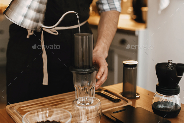 Professional barista preparing coffee in aeropress Stock Photo by Sonyachny