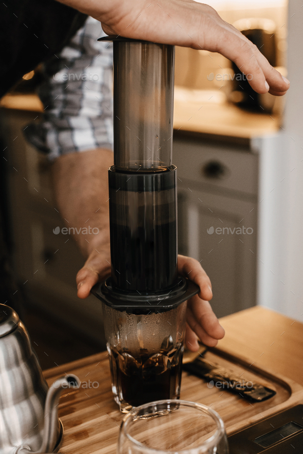 Professional barista preparing coffee in aeropress Stock Photo by Sonyachny