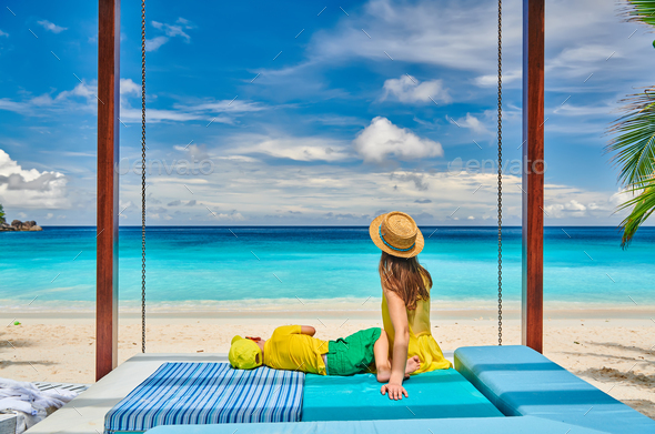 Mother with three year old boy on beach. Seychelles, Mahe. - Stock Photo - Images