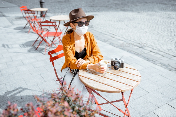 Woman in facial protective mask at the cafe outdoors - Stock Photo - Images