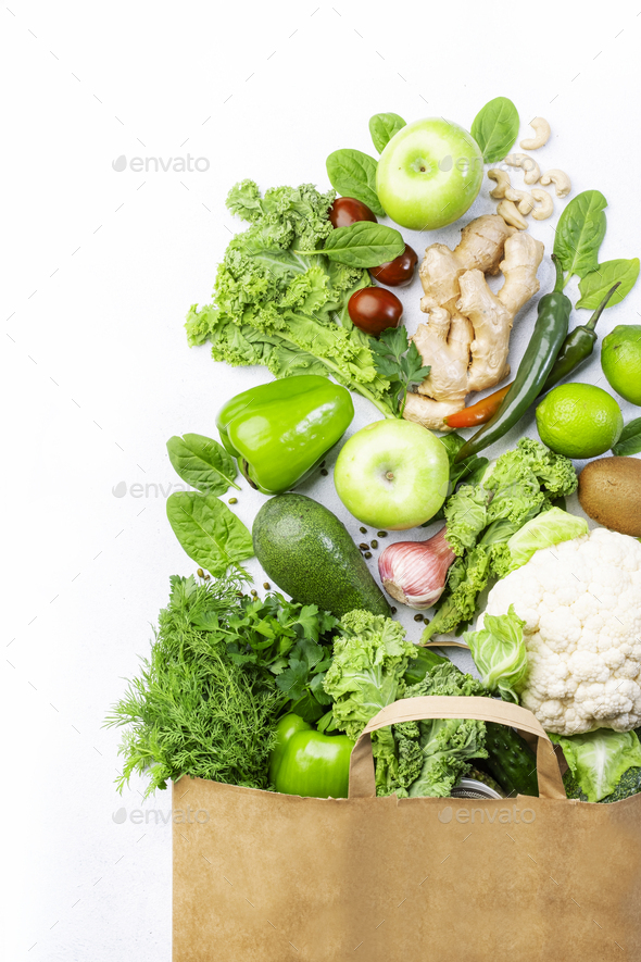 Healthy green vegan vegetarian food in full paper bag - Stock Photo - Images