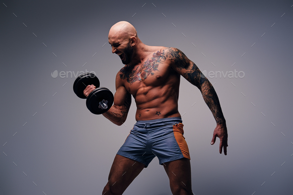 Handsome male with tattoos in his 20s talking on the phone in the gym Stock  Photo - Alamy