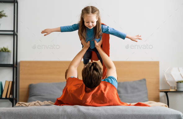 Girl and daddy in Superhero costume - Stock Photo - Images