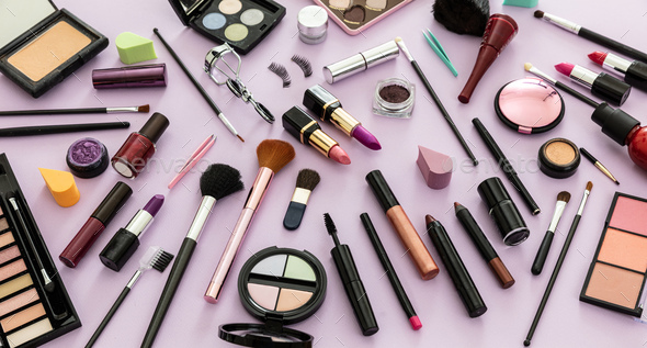 Make up cosmetics products against pastel purple background, - Stock Photo - Images