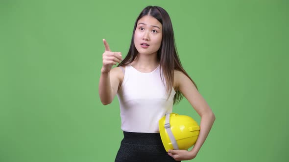 Young Beautiful Asian Businesswoman As Engineer Directing