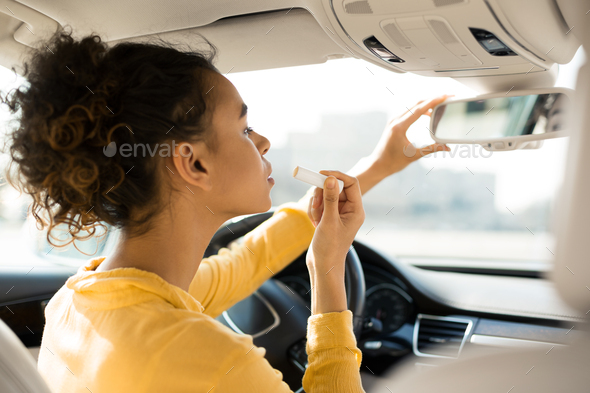 Black Girl Applying Lipstick Sitting In Car Driver\'s Seat
