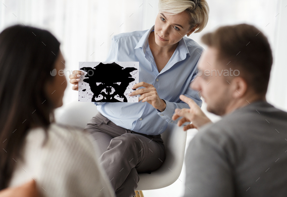 Psychologist Testing Couple Showing Inkblot Picture Sitting In Office - Stock Photo - Images