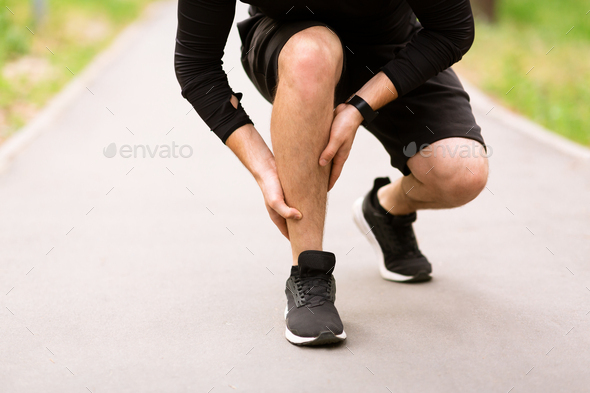 Calf sport muscle injury. Runner with pain in leg