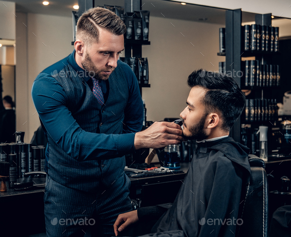 Men's beard grooming with the electronic beard trimmer.