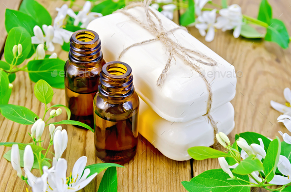 Oil and white soap with flowers of honeysuckle - Stock Photo - Images