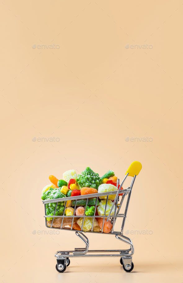 Frozen vegetables assorted on beige, vertical - Stock Photo - Images
