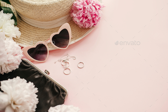 Stylish girly pink retro sunglasses,peonies, jewelry, hat, purse on pastel pink paper