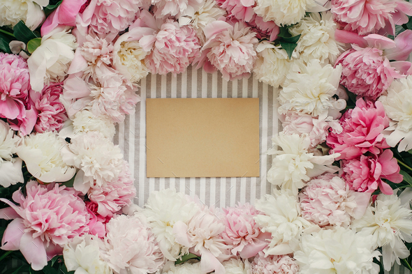 Greeting card template in peonies frame flat lay on rustic table cloth - Stock Photo - Images