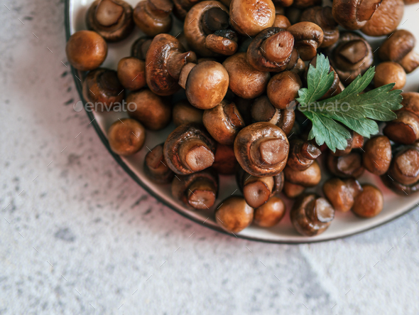Fried mini champignons on plate, copy space - Stock Photo - Images