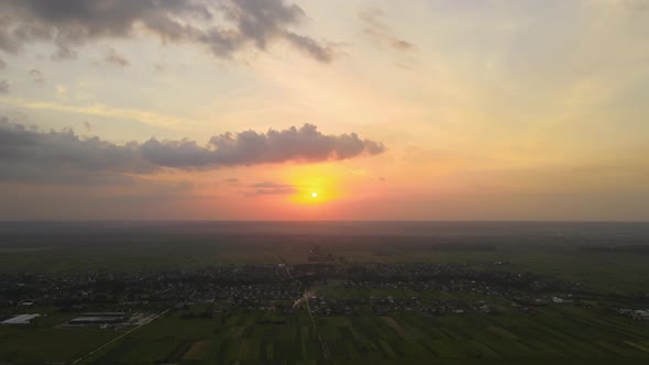 Aerial Landscape View of Village Houses and Distant Green Cultivated Agricultural Fields with alt