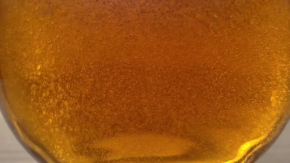 Beer bubbles in transparent glass, slow motion, close up video